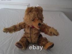Antique 10 in. Golden mohair teddy bear has a squeaker and chain through nose
