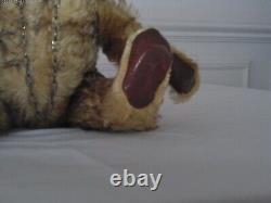 Antique 10 in. Golden mohair teddy bear has a squeaker and chain through nose